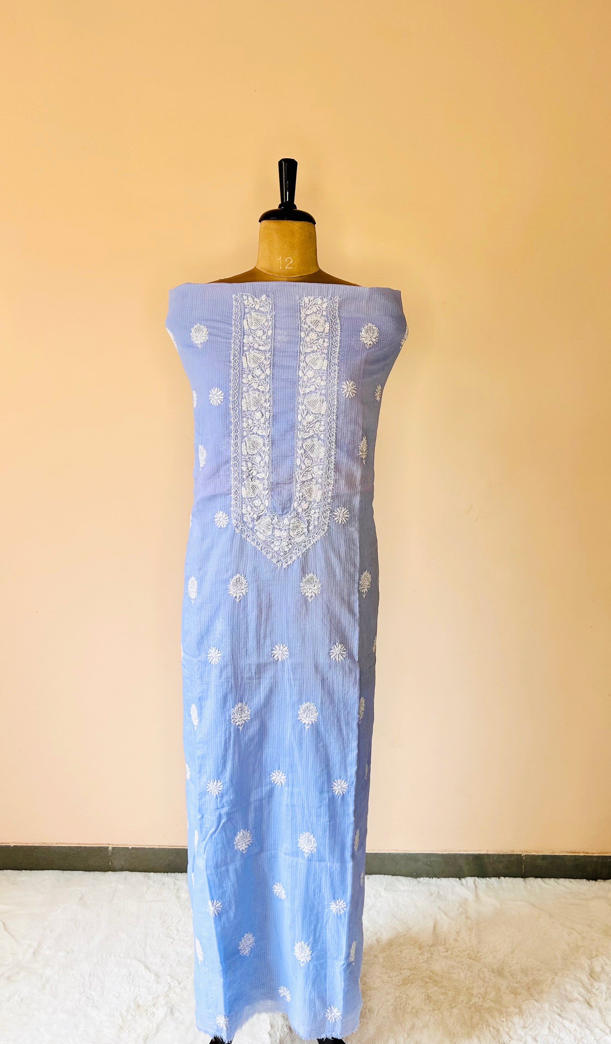 A blue Kota unstitched kurta with pearl and chikankari work of zurrii displayed on a mannequin.