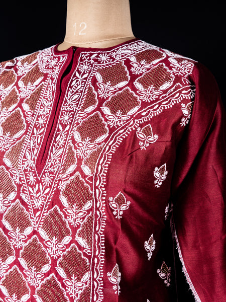 Detailed embroidery on neckline with golden threadwork on red silk fabric